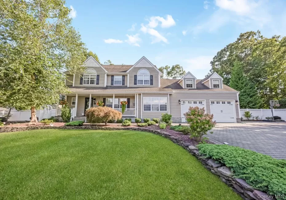 Two-story residence with a covered front porch and dormer windows Two-story residence with a covered front porch and dormer windows