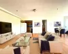 Open-concept living space featuring wood-finish flooring, recessed lighting, and a dining area with a glass-top table Open-concept living space featuring wood-finish flooring, recessed lighting, and a dining area with a glass-top table