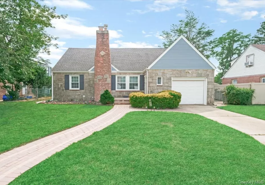 Stone and siding exterior with a prominent brick chimney, attached garage, and a paver walkway Stone and siding exterior with a prominent brick chimney, attached garage, and a paver walkway