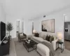 Bright living area featuring light-toned wood-finish flooring and neutral wall tones Bright living area featuring light-toned wood-finish flooring and neutral wall tones