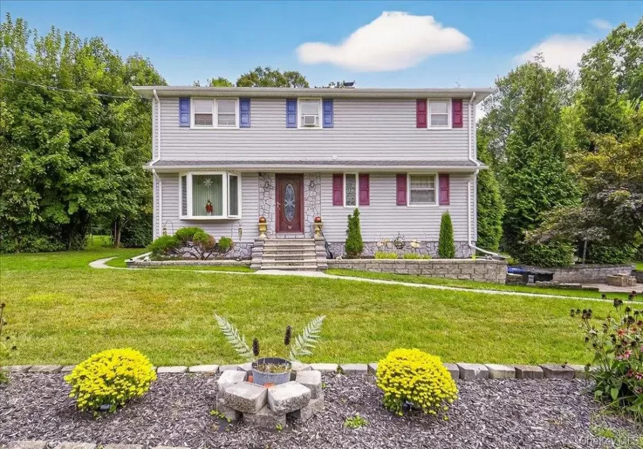 View of front of property featuring a front yard and a fire pit View of front of property featuring a front yard and a fire pit