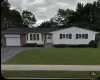 Ranch-style residence featuring white siding, a brick facade, bay windows, and a single-car garage Ranch-style residence featuring white siding, a brick facade, bay windows, and a single-car garage