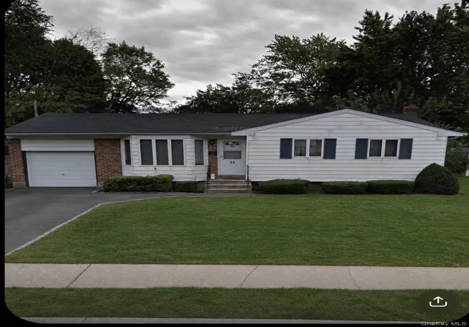 Ranch-style residence featuring white siding, a brick facade, bay windows, and a single-car garage Ranch-style residence featuring white siding, a brick facade, bay windows, and a single-car garage