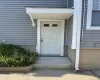 Entry door with upper lites, covered porch, and horizontal siding. Private Entrance to 2nd Floor Apartment Entry door with upper lites, covered porch, and horizontal siding. Private Entrance to 2nd Floor Apartment