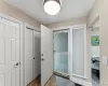 Entry way featuring tiled flooring, a flush-mount ceiling light, white paneled doors, and a front entry door with an adjacent window Entry way featuring tiled flooring, a flush-mount ceiling light, white paneled doors, and a front entry door with an adjacent window