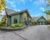 Contemporary exterior with a multi-level roofline, extensive driveway, attached three-car garage, and established landscaping Contemporary exterior with a multi-level roofline, extensive driveway, attached three-car garage, and established landscaping