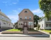 Stucco exterior with a peaked gable and arched window detail Stucco exterior with a peaked gable and arched window detail