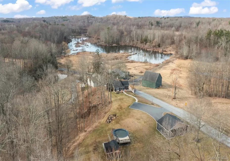 Bird's eye view of the property with a view of the water Bird's eye view of the property with a view of the water
