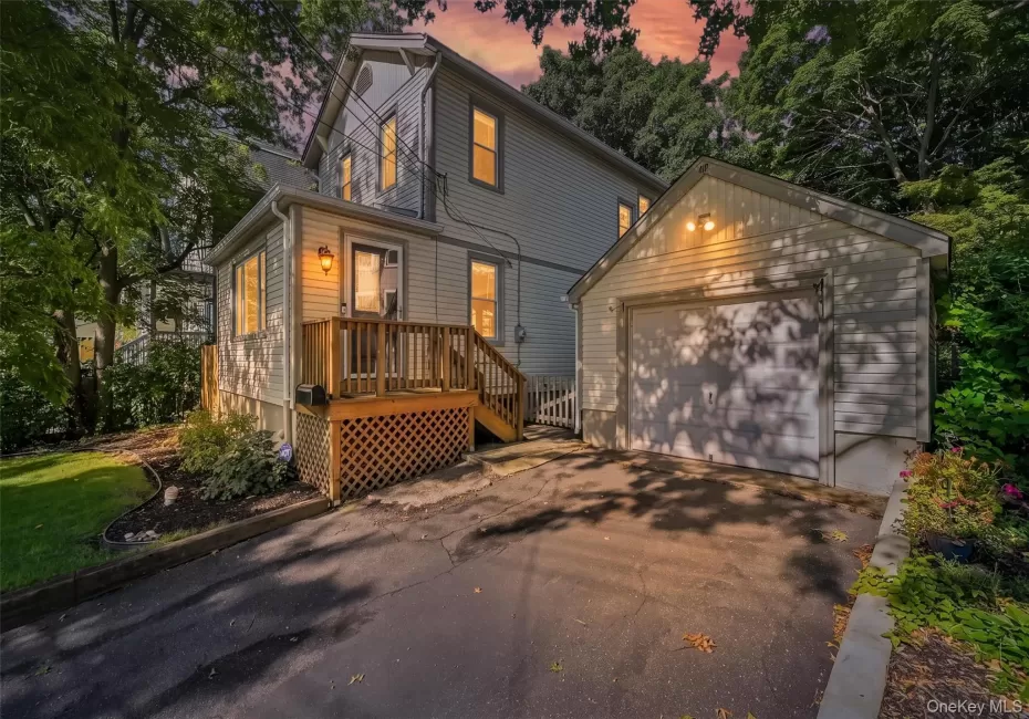 Twilight view of front. Including the detached garage and driveway Twilight view of front. Including the detached garage and driveway