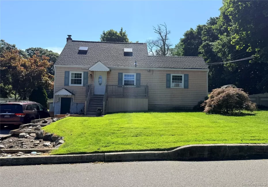 Cape with Shingle siding exterior with a gabled roof and two skylights Cape with Shingle siding exterior with a gabled roof and two skylights