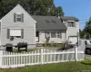 Traditional-style home featuring a shingled roof and an attached garage Traditional-style home featuring a shingled roof and an attached garage