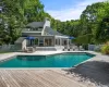 View of pool, a wood deck and home View of pool, a wood deck and home