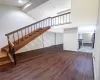 Dramatic foyer featuring tall ceilings, wood flooring, and an open staircase to the loft level. Dramatic foyer featuring tall ceilings, wood flooring, and an open staircase to the loft level.