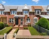 Brick facade with a gabled roofline and bay windows Brick facade with a gabled roofline and bay windows