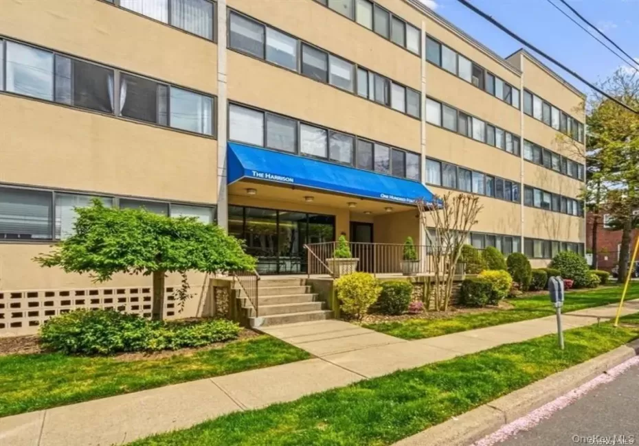 Multi-story building with a stucco exterior Multi-story building with a stucco exterior