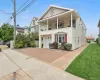 View of front of house with cooling unit, a balcony, a garage, and a front yard View of front of house with cooling unit, a balcony, a garage, and a front yard