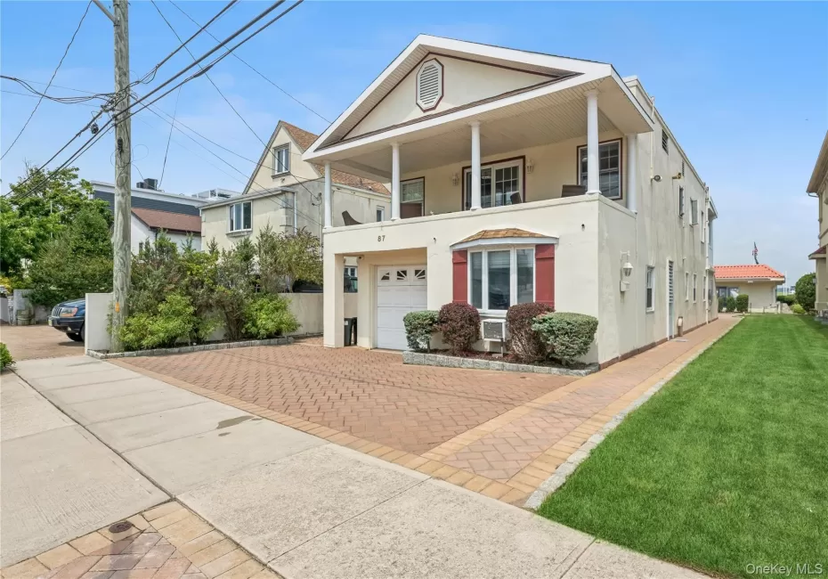 View of front of house with cooling unit, a balcony, a garage, and a front yard View of front of house with cooling unit, a balcony, a garage, and a front yard