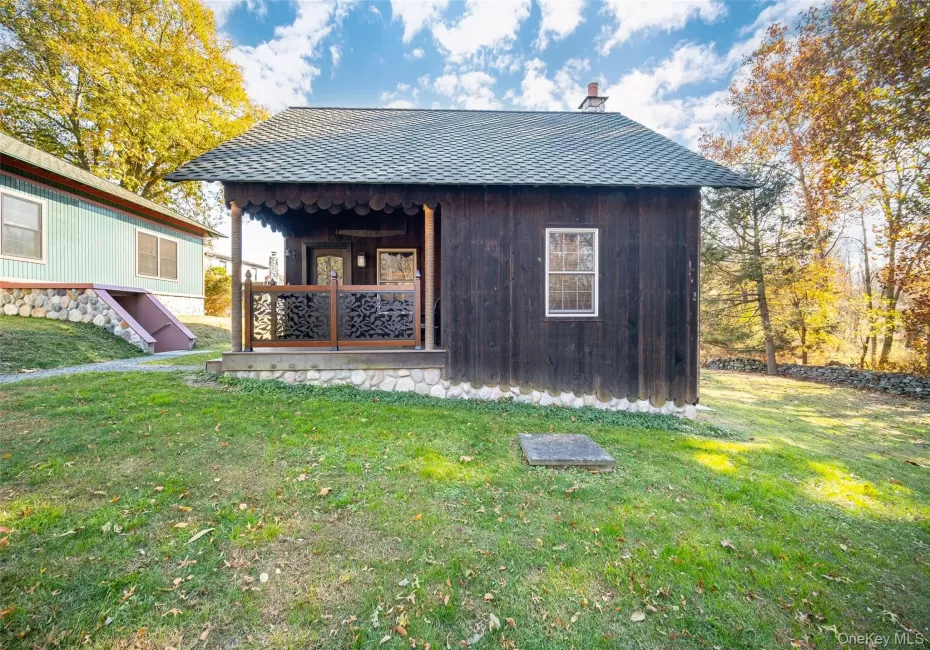 View of outbuilding featuring a lawn View of outbuilding featuring a lawn