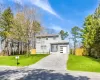 View of front of house with an attached garage, driveway, and a gate View of front of house with an attached garage, driveway, and a gate