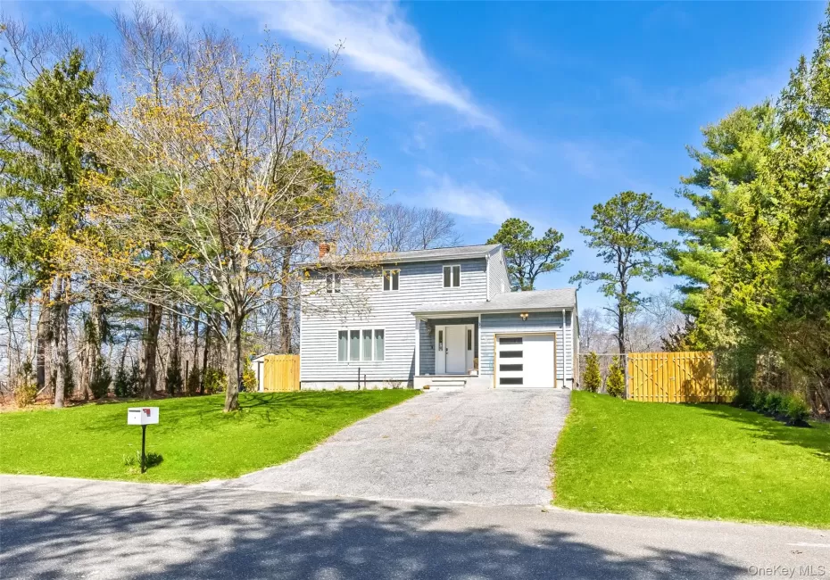 View of front of house with an attached garage, driveway, and a gate View of front of house with an attached garage, driveway, and a gate