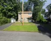 Two asphalt driveways, a front lawn, a detached storage shed, and a covered entry Two asphalt driveways, a front lawn, a detached storage shed, and a covered entry