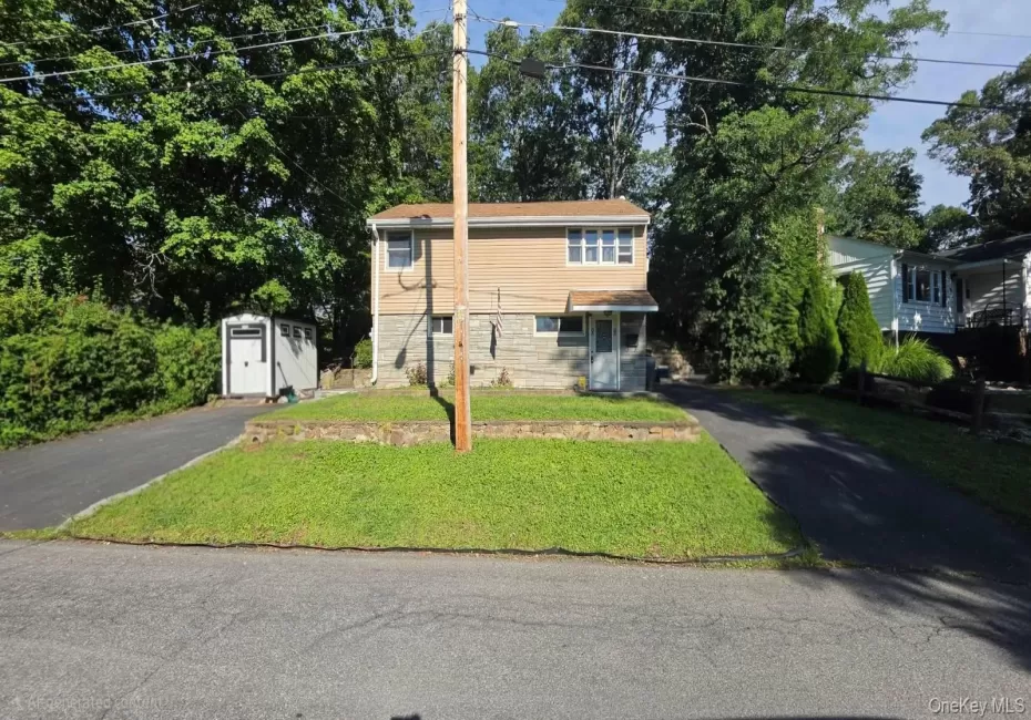 Two asphalt driveways, a front lawn, a detached storage shed, and a covered entry Two asphalt driveways, a front lawn, a detached storage shed, and a covered entry