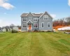 View of front of property with a front lawn and solar panels View of front of property with a front lawn and solar panels