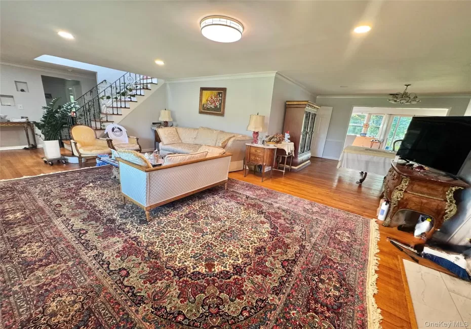 Hardwood flooring throughout, recessed lighting, skylight, and an open stairway with wrought iron balusters Hardwood flooring throughout, recessed lighting, skylight, and an open stairway with wrought iron balusters