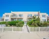 View of front of property featuring stucco siding and a balcony View of front of property featuring stucco siding and a balcony