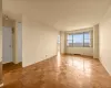Parquet wood-finish flooring, expansive windows, light-toned walls, and recessed lighting Parquet wood-finish flooring, expansive windows, light-toned walls, and recessed lighting