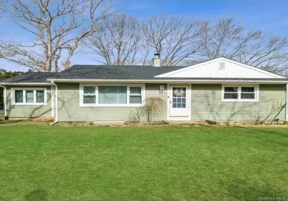 Ranch-style house featuring a front yard, a chimney, a shingled roof, and board and batten siding Ranch-style house featuring a front yard, a chimney, a shingled roof, and board and batten siding