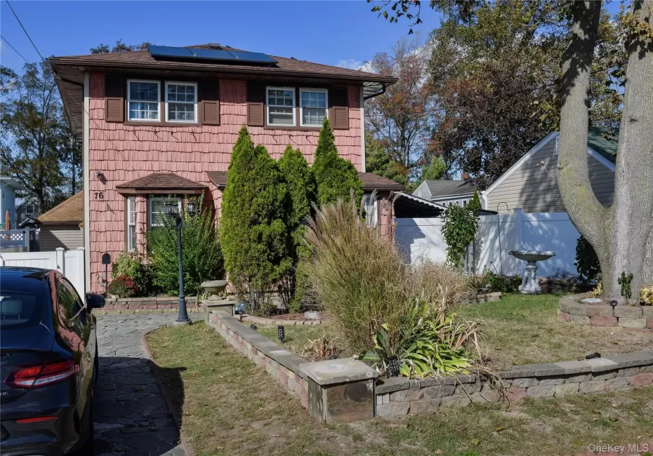 View of front of home with solar panels and roof with shingles View of front of home with solar panels and roof with shingles