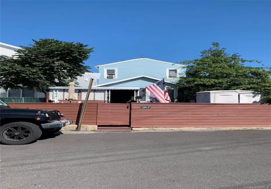 View of front of home with a gate and a fenced front yard View of front of home with a gate and a fenced front yard