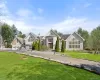 View of front of property featuring a driveway and a front lawn View of front of property featuring a driveway and a front lawn
