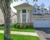 Exterior Street view featuring bay windows, stone facade accents, and a newly paved driveway Exterior Street view featuring bay windows, stone facade accents, and a newly paved driveway