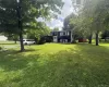 Front exterior view with spacious lawn and mature trees Front exterior view with spacious lawn and mature trees