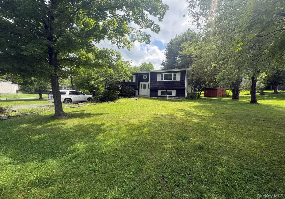 Front exterior view with spacious lawn and mature trees Front exterior view with spacious lawn and mature trees