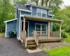 View of front of home with a porch and a shingled roof View of front of home with a porch and a shingled roof