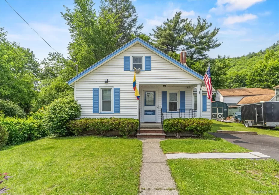 Bungalow-style house featuring a porch, a front yard, and a chimney Bungalow-style house featuring a porch, a front yard, and a chimney