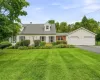 Front view of the home with a spacious lawn and mature landscaping. Front view of the home with a spacious lawn and mature landscaping.