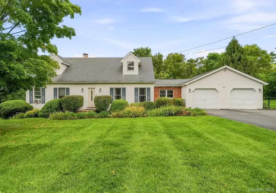 Front view of the home with a spacious lawn and mature landscaping. Front view of the home with a spacious lawn and mature landscaping.
