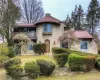 Mediterranean / spanish home featuring a balcony, stucco siding, a chimney, and a tile roof Mediterranean / spanish home featuring a balcony, stucco siding, a chimney, and a tile roof