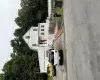 Two-story residence with a multi-car driveway, attached two-car garage, covered entry porch, and partial picket fencing Two-story residence with a multi-car driveway, attached two-car garage, covered entry porch, and partial picket fencing