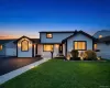 Modern-style exterior featuring a white facade with dark trim, an arched window, and multiple outdoor sconces Modern-style exterior featuring a white facade with dark trim, an arched window, and multiple outdoor sconces