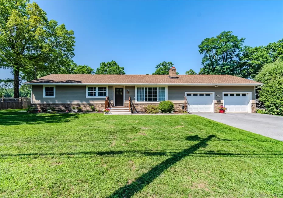 Siding exterior with stone veneer accents, multi-pane windows, covered entry, and attached two-car garage Siding exterior with stone veneer accents, multi-pane windows, covered entry, and attached two-car garage