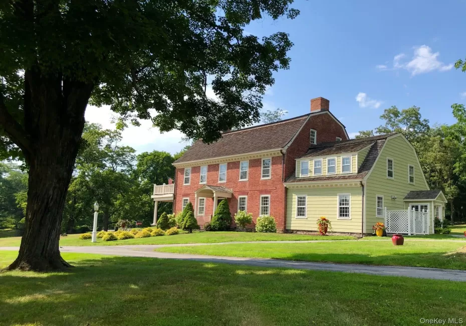 View of front of home with a gambrel roof, a front yard, a chimney, and roof with shingles View of front of home with a gambrel roof, a front yard, a chimney, and roof with shingles