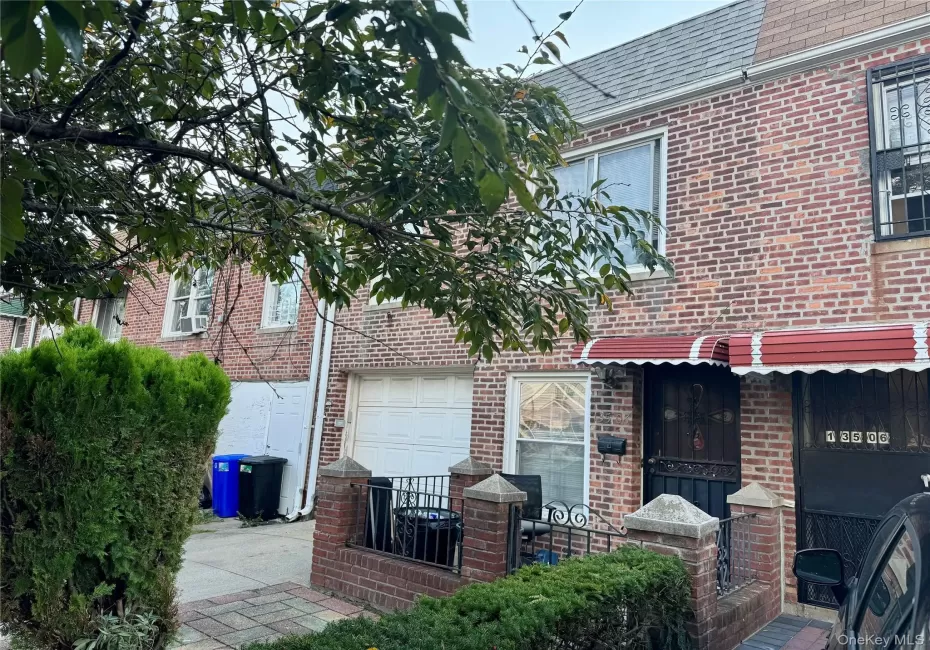 View of front of home featuring brick siding and roof with shingles View of front of home featuring brick siding and roof with shingles