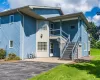 Multi-story exterior with blue siding and contrasting light-colored accents Multi-story exterior with blue siding and contrasting light-colored accents