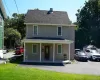 Two-story exterior with siding, covered front porch, asphalt driveway, and a shingled roof Two-story exterior with siding, covered front porch, asphalt driveway, and a shingled roof
