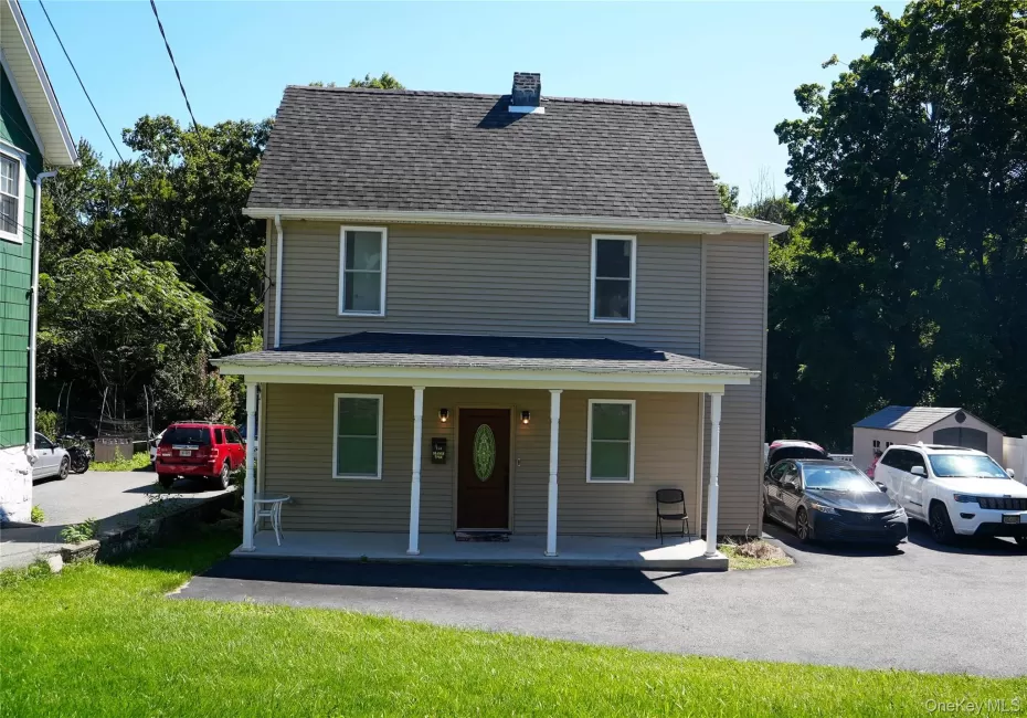 Two-story exterior with siding, covered front porch, asphalt driveway, and a shingled roof Two-story exterior with siding, covered front porch, asphalt driveway, and a shingled roof